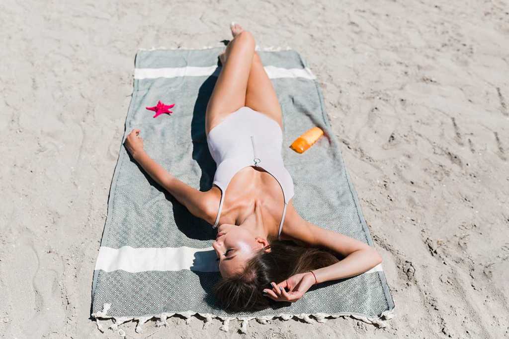 Vitamin D sexy woman sunbathing beach Marbella, Spain