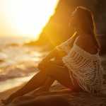 Young Relaxed woman Mindfulness Meditation by the Sea sunset